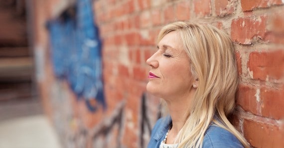 overcoming self doubt woman brick wall
